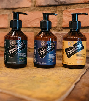 Proraso Cypress & Vetyver, Azur Lime and Wood & Spice Beard Washes sitting on a table.