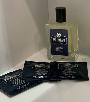 Proraso Azur Lime Refreshing Cologne Tissues and Cologne bottle sitting on the side of a bathroom sink.