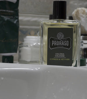 Proraso Cypress & Vetyver Cologne on the bathroom counter with Proraso Refreshing Shave Cream Tube and Proraso Refreshing Pre-Shave Cream in the background.