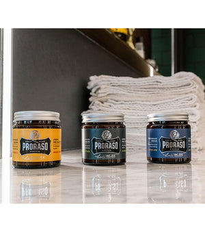Proraso Single Blade Pre-Shave Creams in  three fragrances on counter: Wood and Spice, Cypress & Vetyver and Azur Lime sitting on barber shop counter.