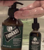 Refresh Beard Wash being pumped into palm of hand next to bathroom sink with Refresh Beard Oil sitting next to it.  Refresh After Shave Lotion in the background.